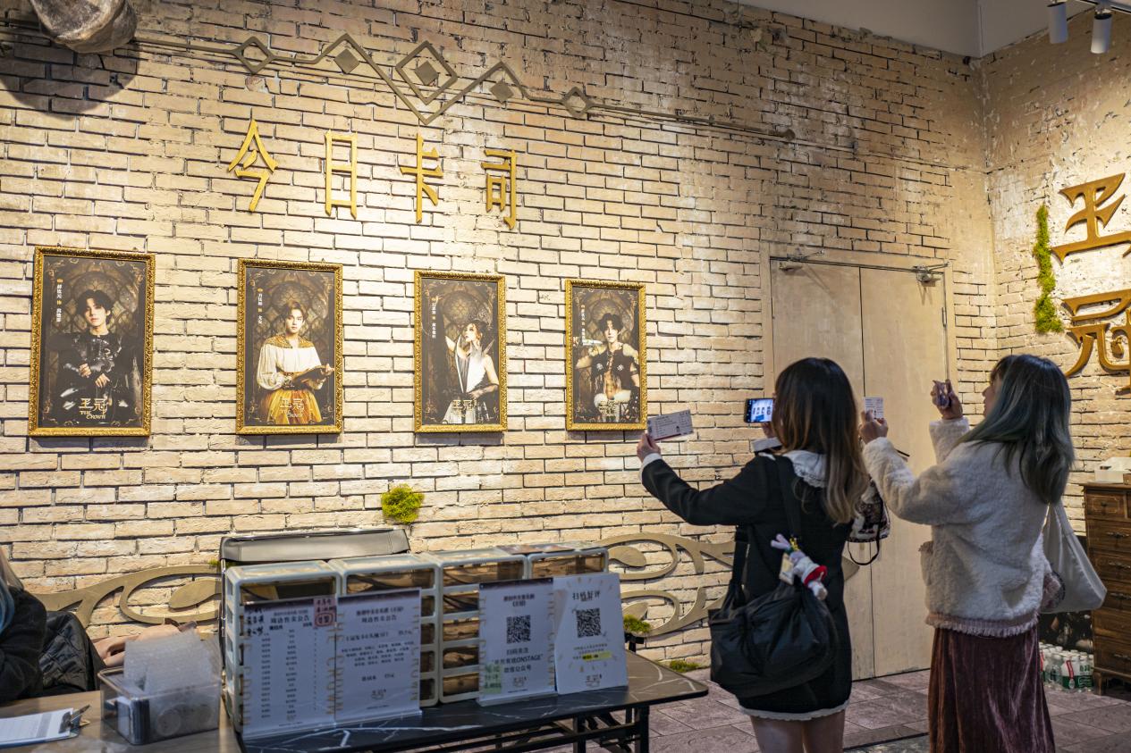七楼音乐剧《王冠》剧场门口,观众开场前拿着票根打卡拍照。
